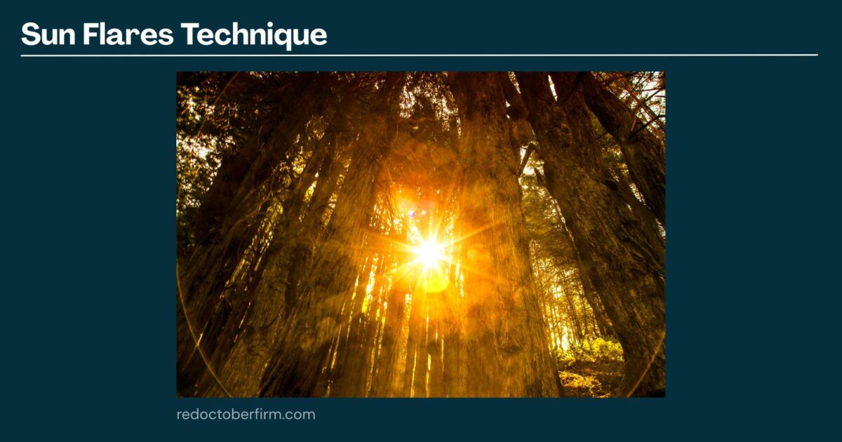 A Bright Sun Flare Shines Through Tall Tree Trunks In A Forest, Creating A Warm Yellow Glow And Rays Of Light.