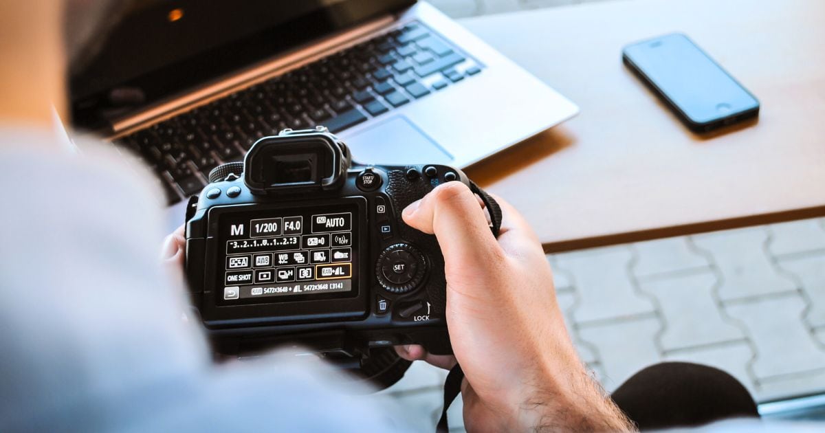 A Beginner Photographer Is Using A Dslr Camera To Capture An Image.