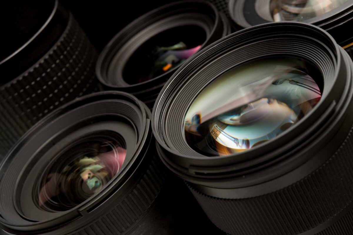 A Collection Of Camera Lenses On A Black Background, Highlighting Common Mistakes Photographers Make.