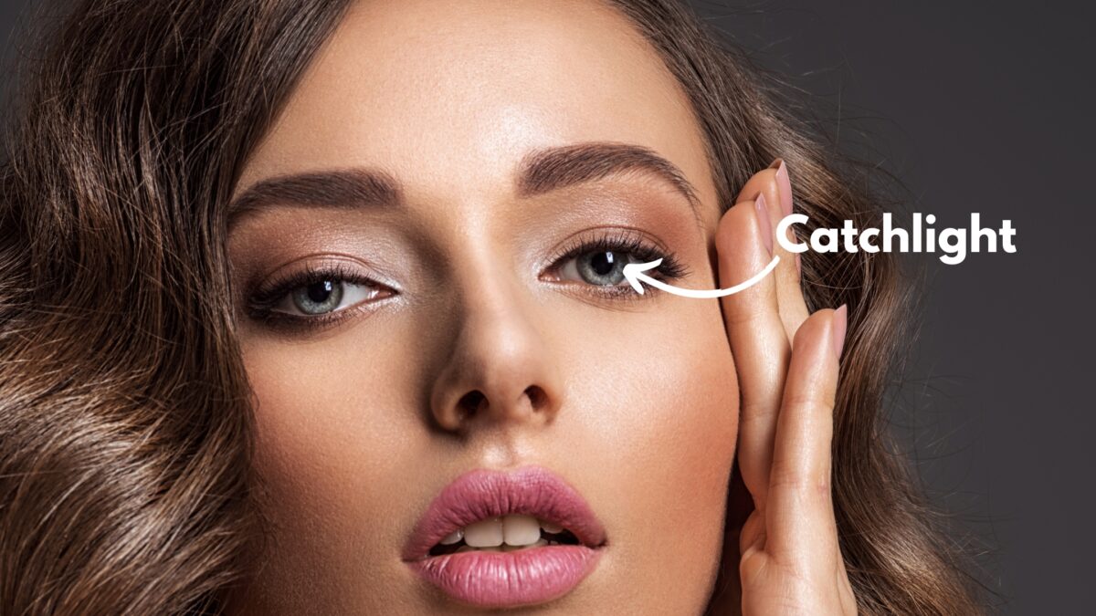 A Woman'S Face With A Captivating Catchlight, Enhanced By A Brilliant Photography Lighting Setup.
