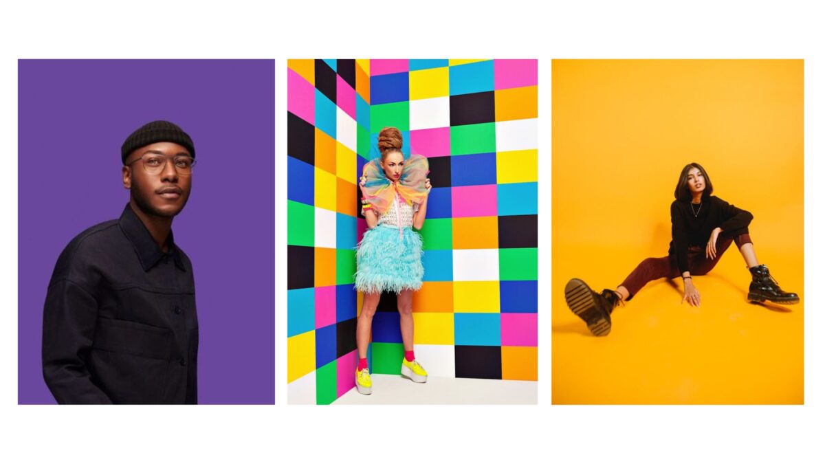 Four People Posing In Front Of A Vibrant Backdrop.