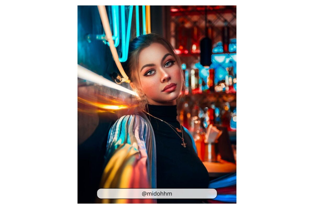An Enchanting Woman Captivates Attention As She Gracefully Poses In Front Of A Bar Adorned With Mesmerizing Neon Lights.