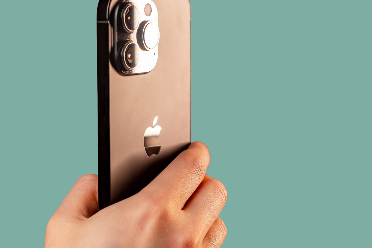 A Person Experimenting With Mobile Photography Tips, Adeptly Capturing Stunning Shots With Their Iphone 11 Featuring An Attached Camera.