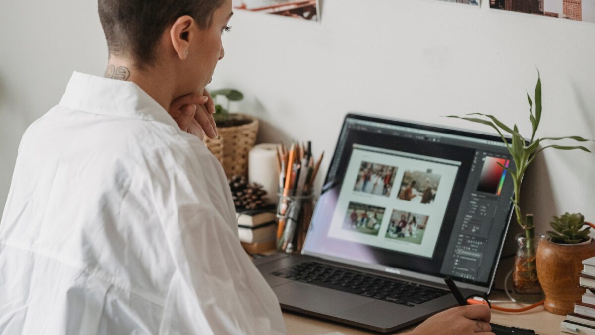 A Woman Is Working On Her Laptop, Creating Perfect Indoor Photos At Home.