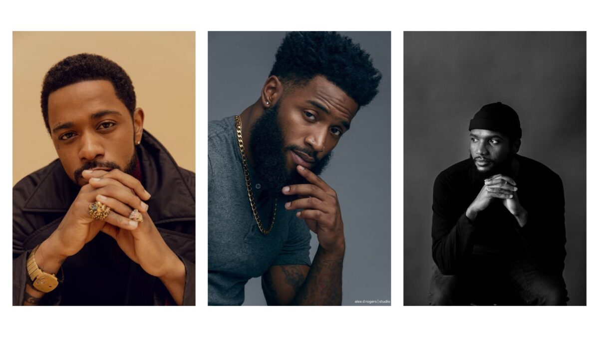 A Black And White Photo Of A Male Model With His Hand On His Chin.