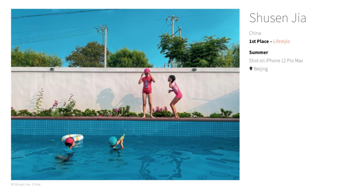 A Woman Enjoying Her Time In A Swimming Pool, Captured With A Smartphone.