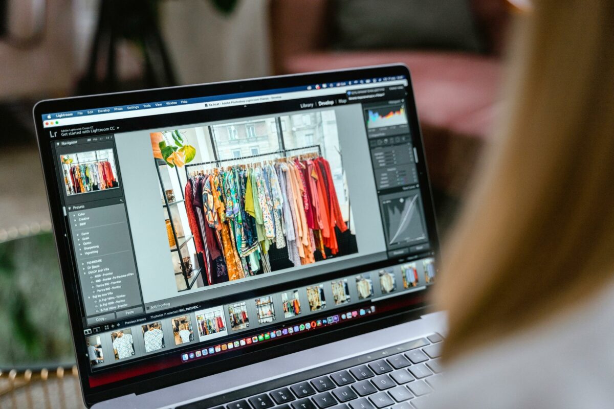 A Woman Is Looking At A Photo On Her Laptop While Learning Photo Editing For Beginners.